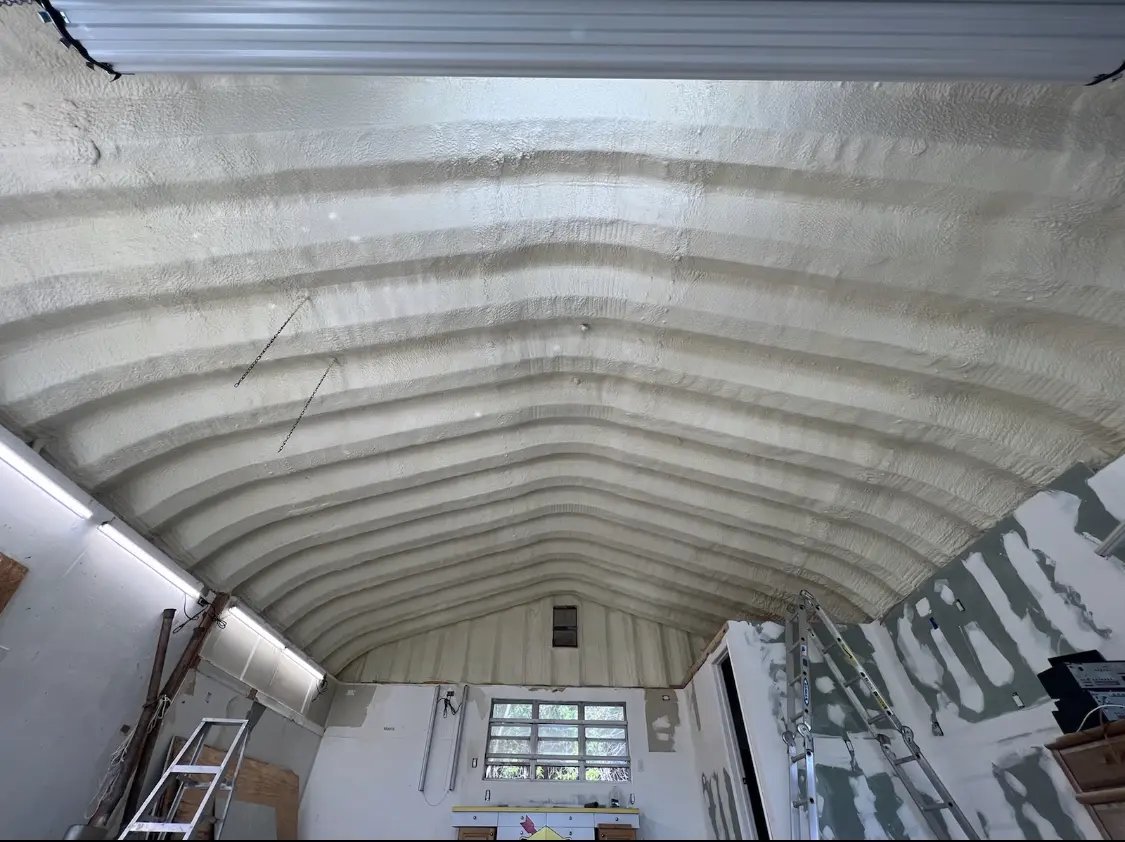 Spray polyurethane foam applied to the underside of a metal roof deck in Quantico Base